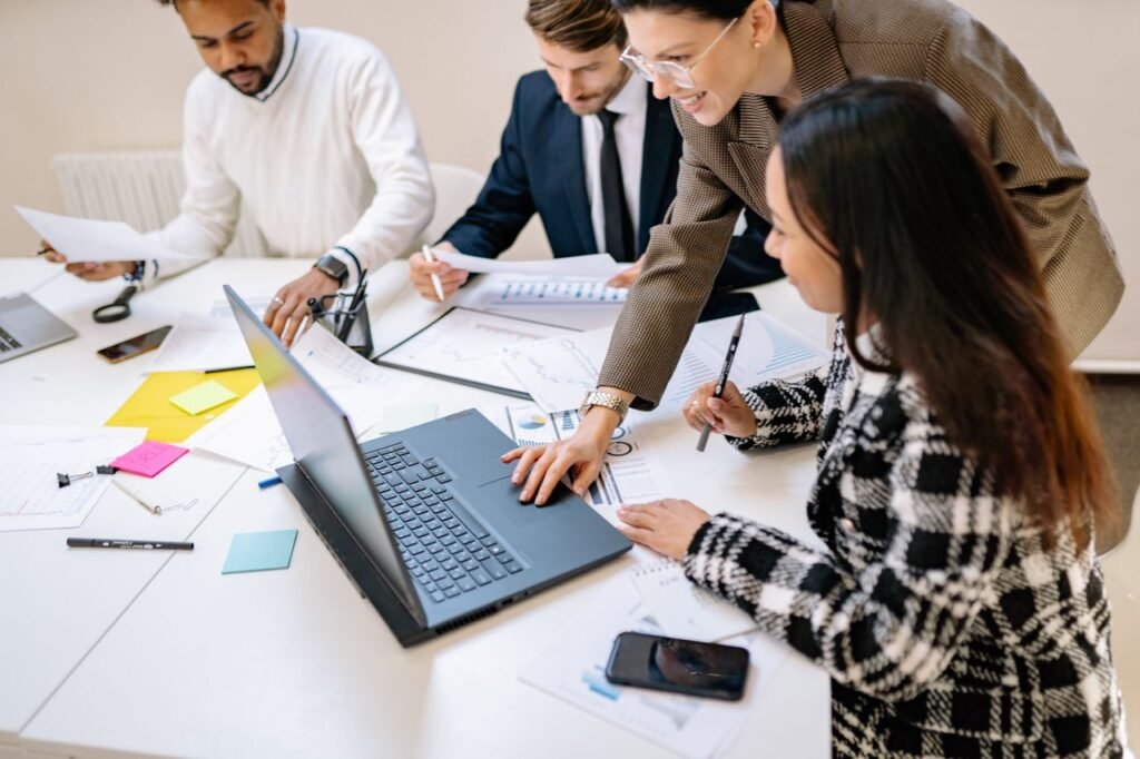 Diverse team working together on a project in a modern office environment.